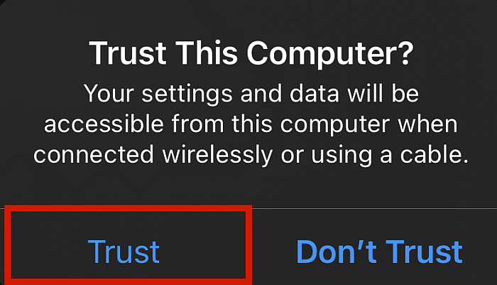 IPhone wyskakujące ostrzeżenie o nieznanym połączeniu z komputerem z podświetloną opcją Trust